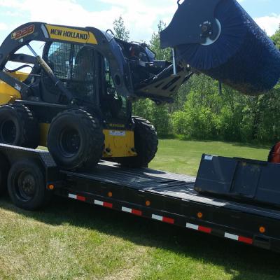 Sweeper used to power broom driveways and parking lots